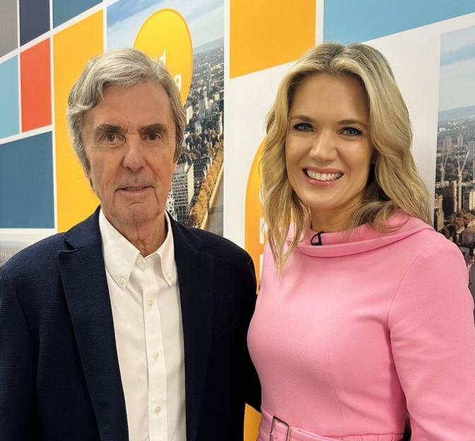 Charlotte Hawkins and John Stapleton standing together.