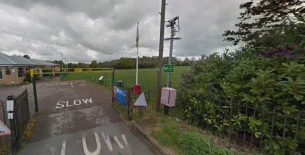 Entrance to a playing field with a security camera.