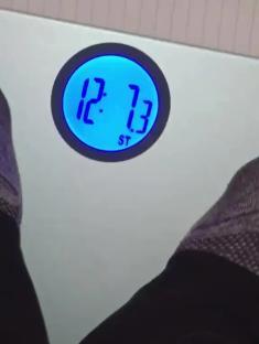 Bathroom scale displaying 12.13.