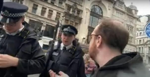 A man speaking with two police officers.