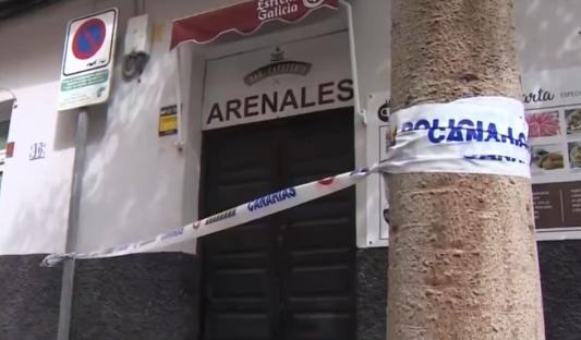 Police tape across the entrance of a bar.