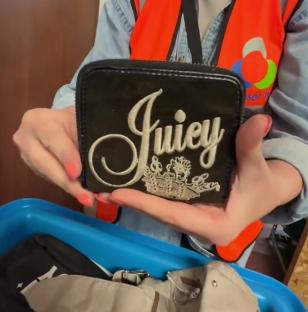 Person holding a Juicy Couture wallet.