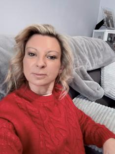 Woman in red sweater regrets her mummy makeover.