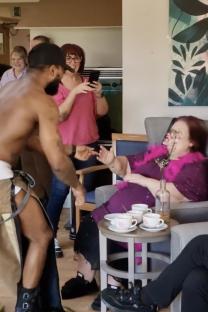 Male stripper performing for care home residents at afternoon tea.
