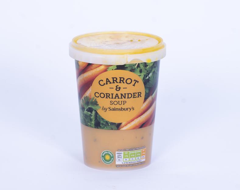 Sainsbury's Carrot & Coriander Soup in a clear plastic tub with a yellow lid.
