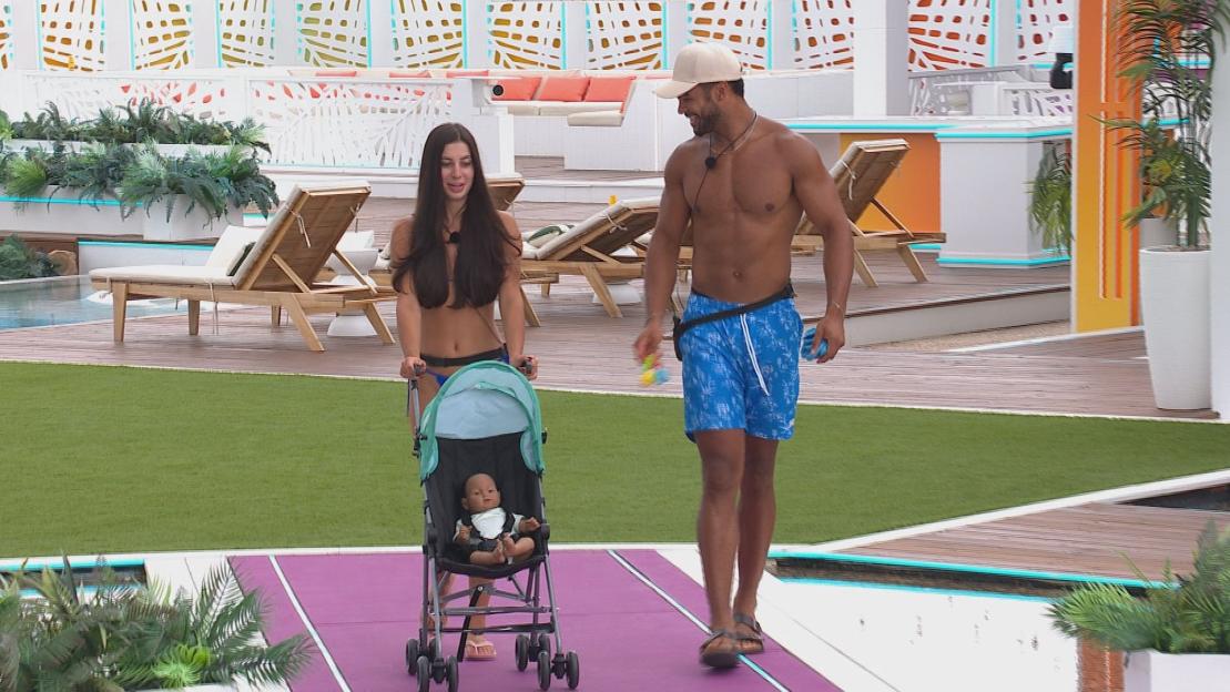 Yasmin and Jamie Allen from Love Island pushing a baby doll in a stroller.