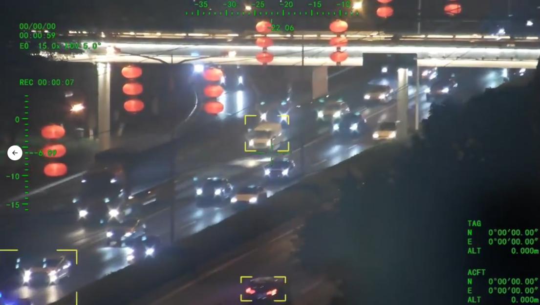 Drone footage of nighttime traffic on a highway.