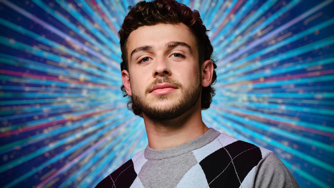 Portrait of a man against a sparkly background.