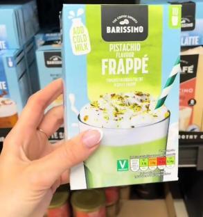 Hand holding a box of Barissimo pistachio flavor frappé mix.