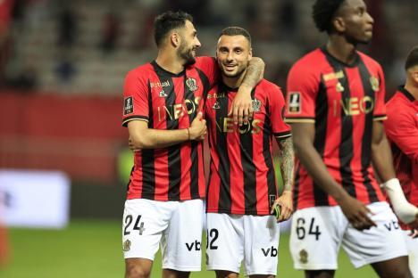 Nice's French forward #24 Gaetan Laborde (L) and Nice's French defender #92 Jonathan Clauss (C) celebrate their team's victory at the end of the French L1 football match between OGC Nice and Stade de Reims at the Allianz Riviera Stadium in Nice, south-eastern France, on May 2, 2025. (Photo by Valery HACHE / AFP) (Photo by VALERY HACHE/AFP via Getty Images)