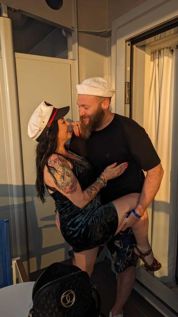 Couple embracing on a balcony.