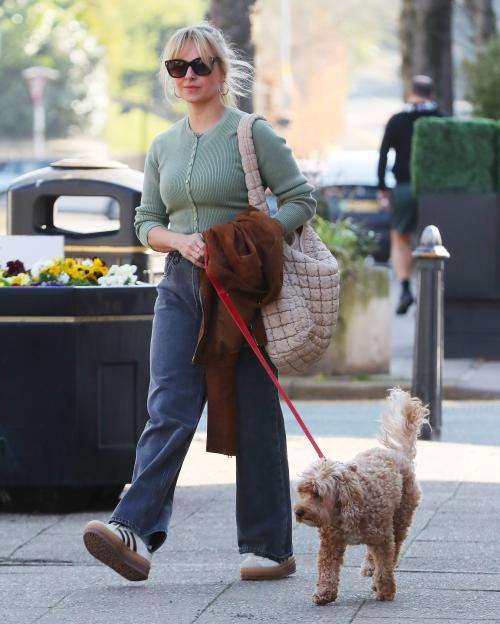 Woman walking a small dog.