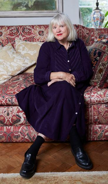 Olivia Fane sits on a floral couch at home, warning against the perils of open marriage.