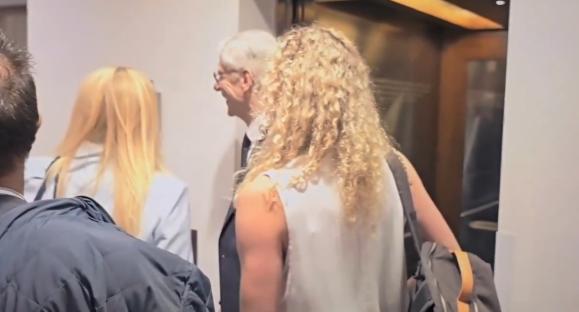 People walking down a hallway.