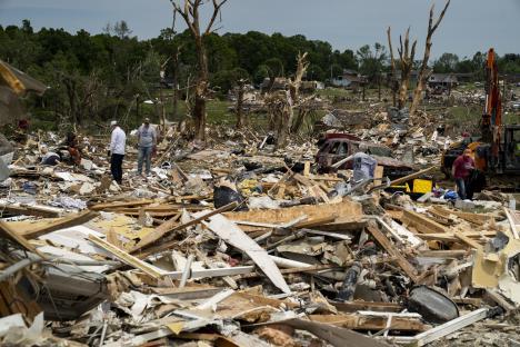 Debris and people cleaning up after a tornado.