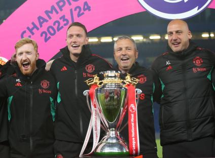 Manchester United U18 coaches with the Premier League National Final trophy.