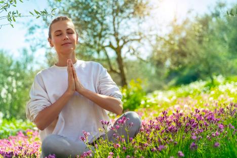 Woman meditating in a garden.