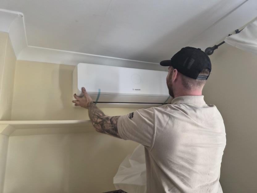 Technician installing a Bosch air conditioner.