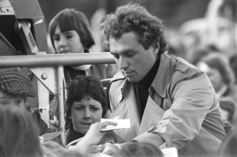 Jochen Mass signing autographs for fans.