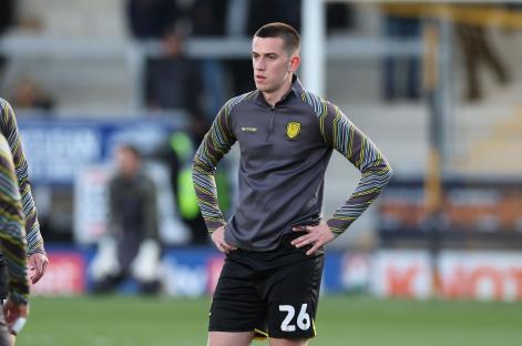 Burton Albion defender Finn Delap warming up before a match.