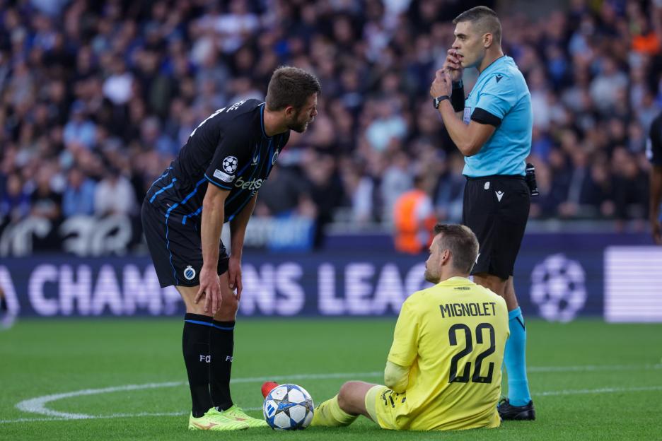 Goalkeeper Simon Mignolet of Club Brugge sits on the pitch during a UEFA Champions League match.