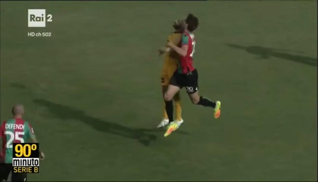 Two soccer players in mid-air competing for a header.