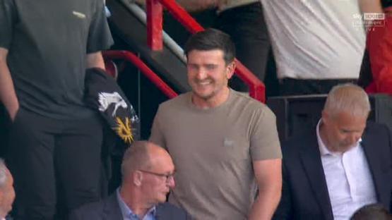 A man smiling in a stadium.