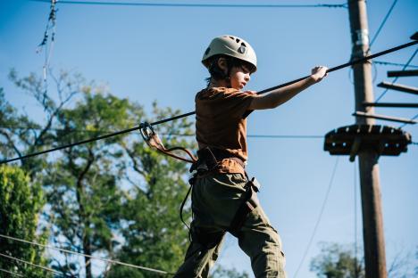 Boy on an outdoor ropes course.