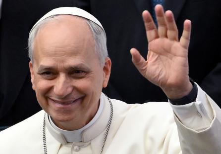 Pope Leo XIV waving to the media.