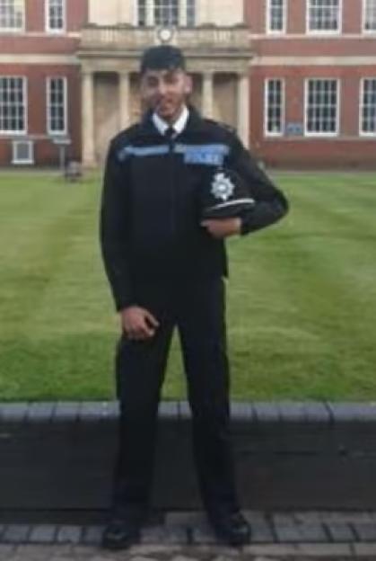 PC Faizaan Najeeb in uniform holding his police hat.