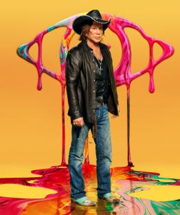 Mickey Rourke standing in spilled paint, promotional image for Celebrity Big Brother.
