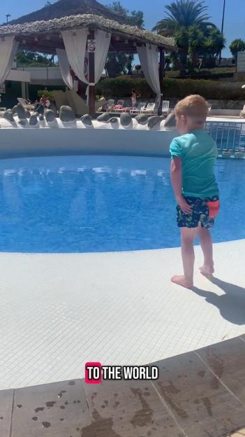 Young boy at a resort pool.