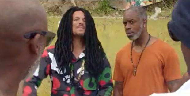 Still image from a movie featuring Peter Andre in dreadlocks and a Jamaican accent.
