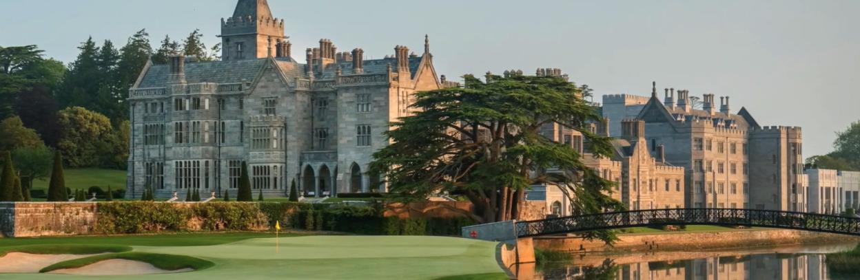 Adare Manor with a golf course and river in front.