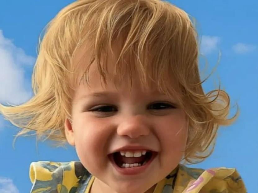 Happy toddler with blond hair.