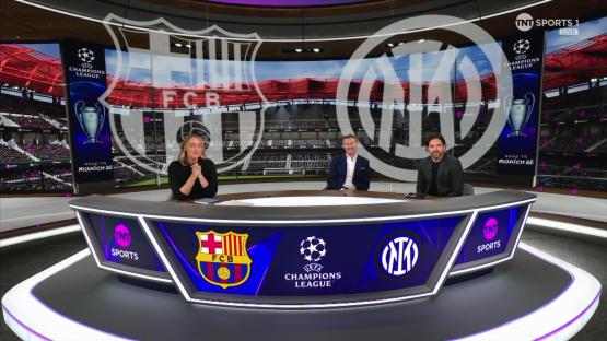Three sportscasters sitting at a desk in a studio set featuring FC Barcelona and Inter Milan logos and Champions League branding.