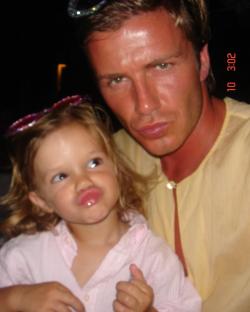 David Beckham and his young daughter making funny faces.