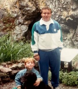 Photo of Matthew Harding and his son Patrick Harding with a dog.