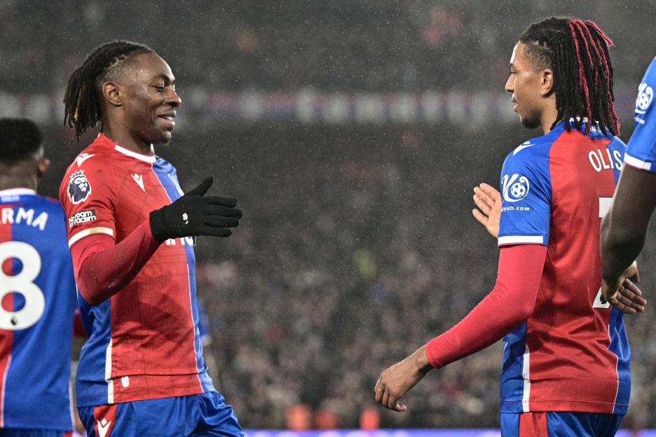 Michael Olise and Eberechi Eze of Crystal Palace celebrating a goal.