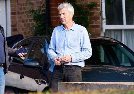 Homeowner Nick Tweddle speaks to a reporter about beehives causing problems.
