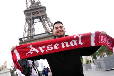 Arsenal fan in Paris holding a red scarf with