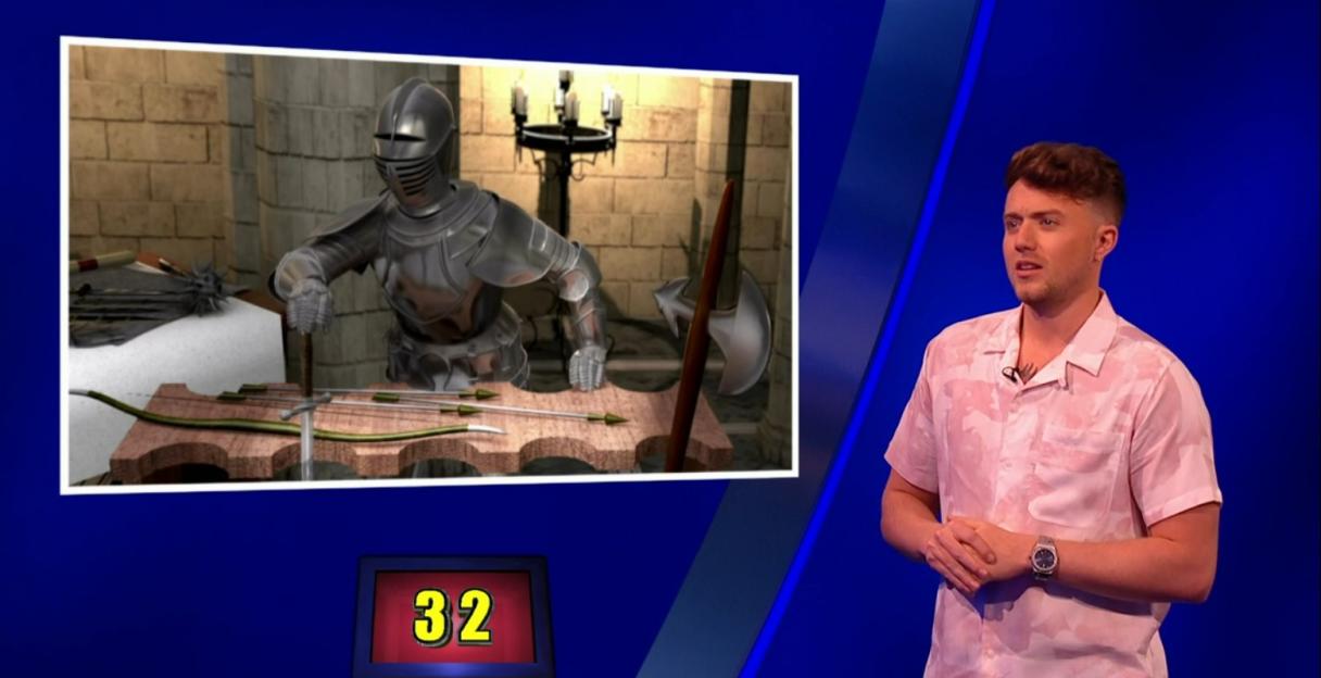 Screenshot from Celebrity Catchphrase showing a knight and weapons, and a contestant.