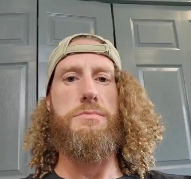 A bearded man wearing a baseball cap.