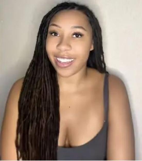 A woman with long dreadlocks.