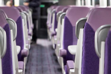 Empty purple train seats.