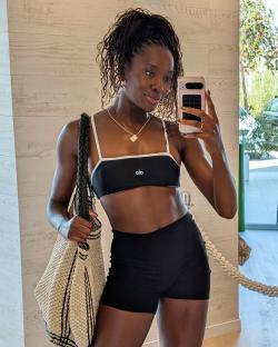 Woman taking a selfie in athletic wear.