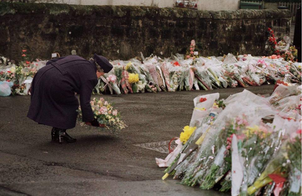 Queen Elizabeth placing a floral bouquet at Dunblane Primary School.