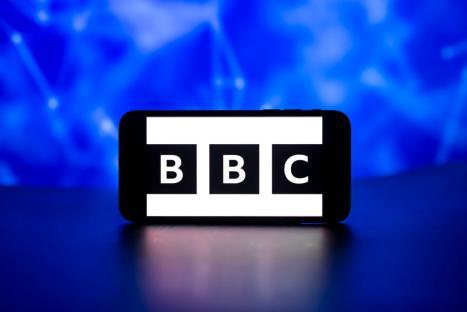Photo illustration of the BBC logo on a phone screen.