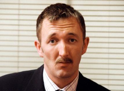 Headshot of a man with a mustache.