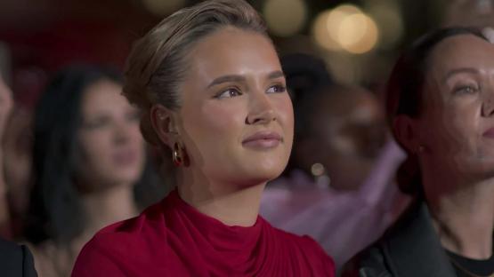 Molly-Mae Hague in a red dress at an event.